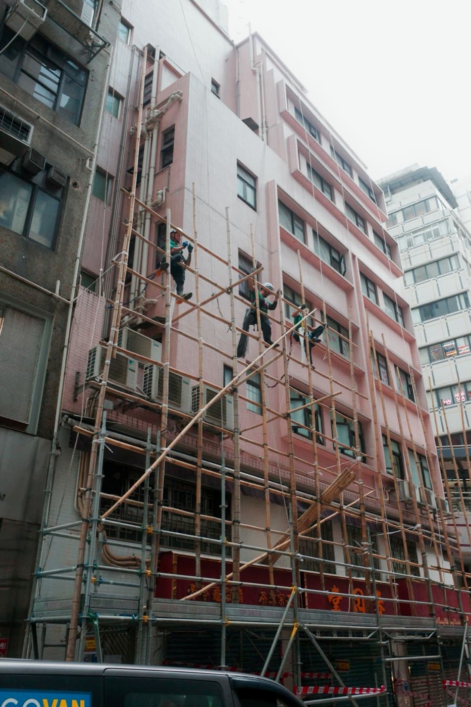 Bamboo scaffolding on a pink building