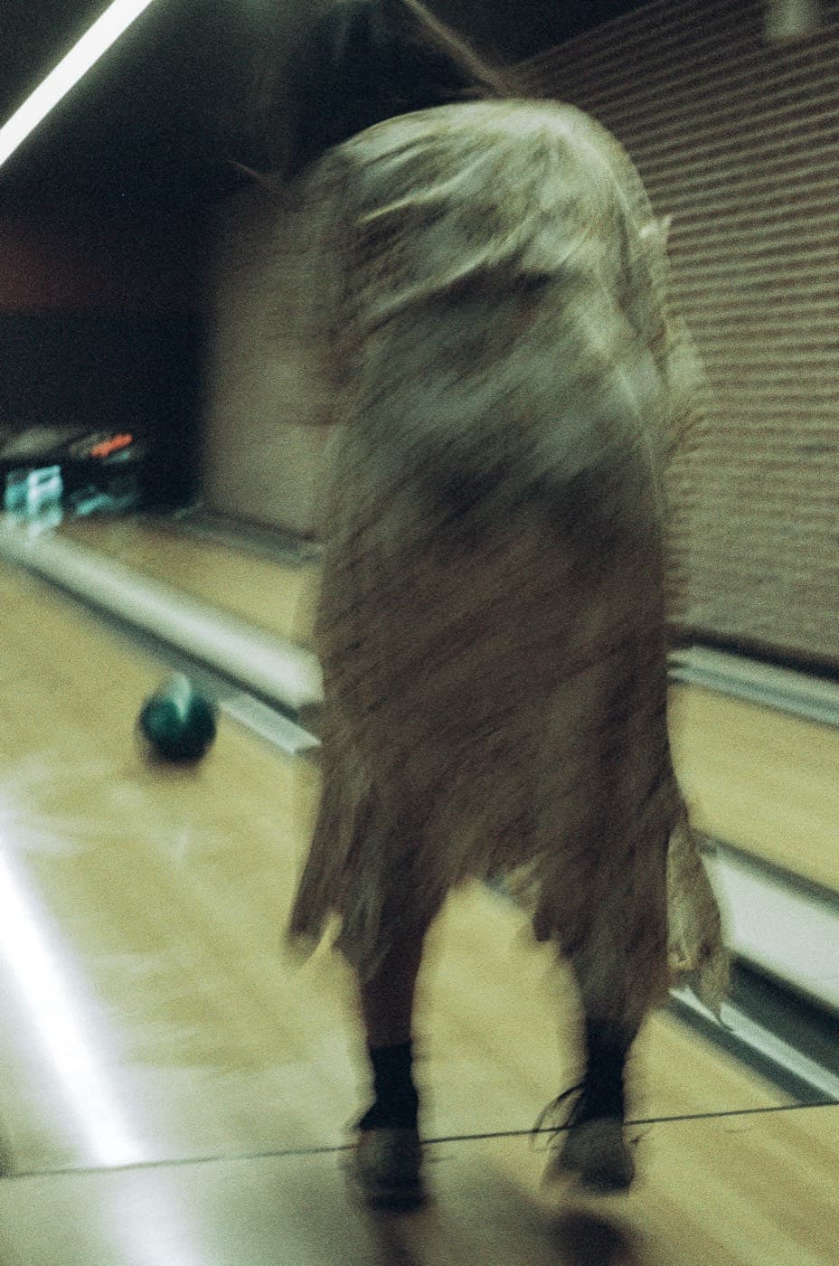 Bowler from behind, motion blur, shot on 35mm